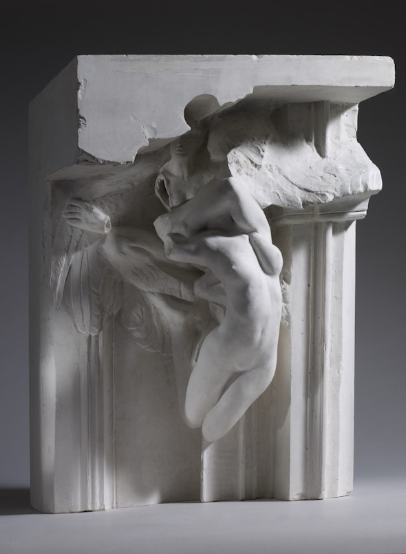 A Rodin sculpture in which a headless female form appears to emerge from the upper part of a doorframe.