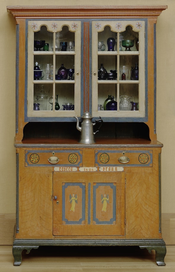 <p>This 1828 cupboard by Pennsylvania German cabinetmaker Michael Braun is packed with early American glass.</p>